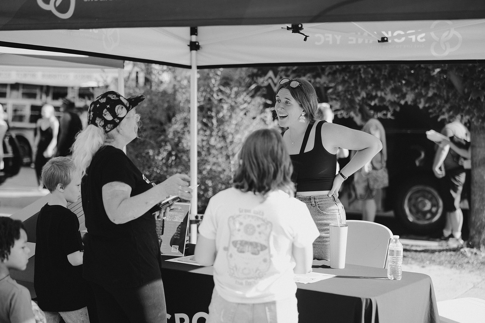 two people asking questions at a booth